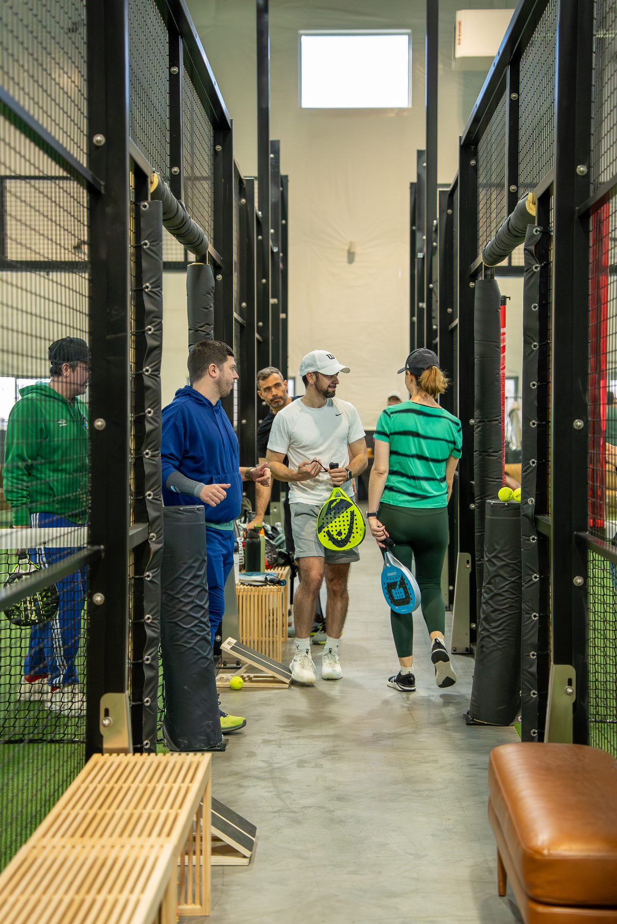 Access Padel community gathering between courts