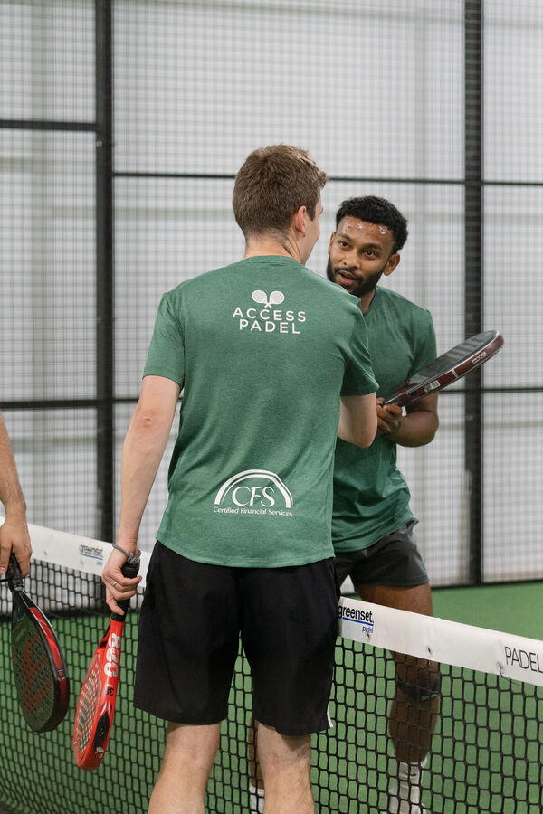 Players chatting in Access Padel shirts