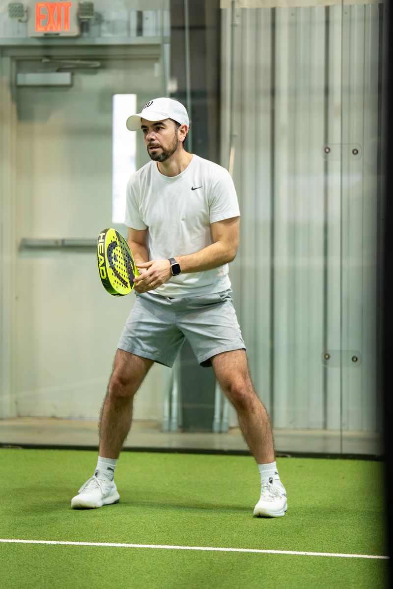 Focused player in ready position at Access Padel